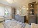 Elegant bathroom featuring a chandelier, vanity, and a soaking tub at 1227 Golden Ln, Orlando, FL 32804
