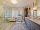Elegant bathroom featuring a marble shower, soaking tub, vanity, and a chandelier at 1227 Golden Ln, Orlando, FL 32804