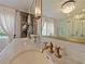 Bright bathroom with double sink vanity, gold fixtures, marble counters, and a glass enclosed shower at 1227 Golden Ln, Orlando, FL 32804