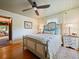 Bright bedroom with a queen-sized bed, a ceiling fan, and hardwood floors at 1227 Golden Ln, Orlando, FL 32804