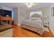 Well-lit bedroom featuring hardwood floors, a comfortable bed, and stylish decor at 1227 Golden Ln, Orlando, FL 32804