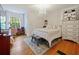 Charming bedroom featuring hardwood floors, chandelier and ample natural light at 1227 Golden Ln, Orlando, FL 32804