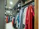 Walk in closet with custom shelving and hanging rods, providing ample storage space at 1227 Golden Ln, Orlando, FL 32804