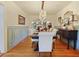 Dining room features a wood table, upholstered chairs, hardwood floors, and a dark wood sideboard at 1227 Golden Ln, Orlando, FL 32804