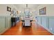 Formal dining room featuring hardwood floors, wainscotting and a decorative chandelier at 1227 Golden Ln, Orlando, FL 32804