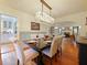 Dining room featuring a wood table, upholstered chairs, hardwood floors, and view to a fireplace at 1227 Golden Ln, Orlando, FL 32804