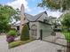 Charming home featuring a brick chimney, lush landscaping, and a paved driveway at 1227 Golden Ln, Orlando, FL 32804