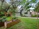 A charming house with beautiful landscaping, raised garden beds, and an inviting green lawn at 1227 Golden Ln, Orlando, FL 32804