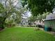 A charming home with lush landscaping, mature trees, and a well-manicured lawn at 1227 Golden Ln, Orlando, FL 32804