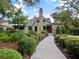 Quaint home featuring immaculate landscaping, a brick chimney, and a garden at 1227 Golden Ln, Orlando, FL 32804
