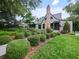 Quaint home featuring immaculate landscaping, a brick chimney, and a garden at 1227 Golden Ln, Orlando, FL 32804