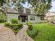 Inviting two-story home with manicured landscaping and a brick walkway leading to the entrance at 1227 Golden Ln, Orlando, FL 32804