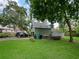 Two-story garage with parking and a storage shed, nestled among mature trees and lush landscaping at 1227 Golden Ln, Orlando, FL 32804