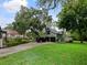 Charming two-story garage with a black car parked in the driveway on a well-maintained lawn at 1227 Golden Ln, Orlando, FL 32804