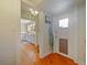 Hallway view into kitchen featuring hardwood floors and white trim at 1227 Golden Ln, Orlando, FL 32804