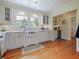 Kitchen with white cabinets, farmhouse sink, hardwood floors and lots of natural light at 1227 Golden Ln, Orlando, FL 32804
