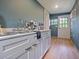 Well-lit kitchenette with a stainless steel sink, coffee maker, and white cabinetry at 1227 Golden Ln, Orlando, FL 32804