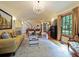 Spacious living room with chandelier, hardwood floors, and large window featuring beautiful curtains at 1227 Golden Ln, Orlando, FL 32804