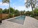 Inviting backyard pool with a tranquil fountain, surrounded by a stone patio and lush landscaping at 1227 Golden Ln, Orlando, FL 32804