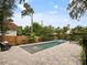 Inviting backyard pool with a tranquil fountain, surrounded by a stone patio and lush landscaping at 1227 Golden Ln, Orlando, FL 32804