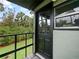 Cozy porch with a glass-paneled door and a charming view of the lush, green surroundings at 1227 Golden Ln, Orlando, FL 32804