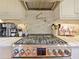 Close-up of stainless steel gas range with marble backsplash and pot filler faucet at 1227 Golden Ln, Orlando, FL 32804