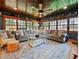 Cozy sunroom with wood ceiling, fan, many windows, and comfortable seating at 1227 Golden Ln, Orlando, FL 32804