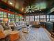 Cozy sunroom with wood ceiling, fan, many windows, and comfortable seating at 1227 Golden Ln, Orlando, FL 32804