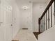 Bright entryway with tiled floors, coat closet, and staircase with wrought iron railings at 1277 Blessing St, Maitland, FL 32751