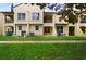 Rear exterior view of a yellow townhome with a well-maintained lawn at 1277 Blessing St, Maitland, FL 32751