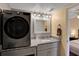 Modern bathroom featuring a washer, granite countertops, and updated fixtures at 145 Oyster Bay Cir # 140, Altamonte Springs, FL 32701