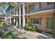 Well-maintained condo building featuring green shutters and manicured landscaping at 145 Oyster Bay Cir # 140, Altamonte Springs, FL 32701
