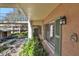 Exterior of condo unit with green shutters, mature landscaping, and access to a walkway at 145 Oyster Bay Cir # 140, Altamonte Springs, FL 32701