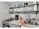 Well-equipped kitchen with modern gas range, granite countertop, and open shelving at 145 Oyster Bay Cir # 140, Altamonte Springs, FL 32701