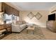 Well-lit living room offering a sectional sofa, natural light, and modern accents at 145 Oyster Bay Cir # 140, Altamonte Springs, FL 32701