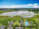 Aerial view of the community with a large lake, pool, clubhouse, and ample parking at 1540 Orange Valley Rdg, Ocoee, FL 34761