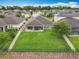 A backyard with a well-kept lawn, patio, and barbecue grill in a community setting at 1540 Orange Valley Rdg, Ocoee, FL 34761