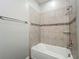 The bathtub has tile walls, a shower head, and a towel bar in this bathroom at 1540 Orange Valley Rdg, Ocoee, FL 34761