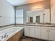 Bathroom with double sink vanity, granite countertop, soaking tub and walk-in shower at 1540 Orange Valley Rdg, Ocoee, FL 34761
