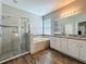 Bathroom featuring walk-in shower, soaking tub, granite countertop and wood-look flooring at 1540 Orange Valley Rdg, Ocoee, FL 34761
