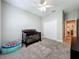 A carpeted bedroom with natural light, a ceiling fan, and closet space is ready for comfortable living at 1540 Orange Valley Rdg, Ocoee, FL 34761