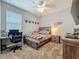 A comfortably furnished bedroom with a ceiling fan, natural light, carpet flooring, and contemporary decor at 1540 Orange Valley Rdg, Ocoee, FL 34761