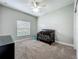 This cozy bedroom features carpet flooring, a ceiling fan, and a well-lit atmosphere at 1540 Orange Valley Rdg, Ocoee, FL 34761