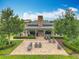 Aerial view of the clubhouse with patio, outdoor seating, lush landscaping, and mature trees at 1540 Orange Valley Rdg, Ocoee, FL 34761