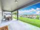 Covered patio with outdoor furniture and a view of the green backyard and neighborhood at 1540 Orange Valley Rdg, Ocoee, FL 34761