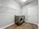 Laundry room with side-by-side washer and dryer on wood-look flooring at 1540 Orange Valley Rdg, Ocoee, FL 34761