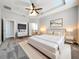 Bright main bedroom featuring tray ceiling, plush carpet, and ensuite bathroom at 1540 Orange Valley Rdg, Ocoee, FL 34761