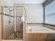 Tiled walk-in shower with glass surround and soaking tub at 1540 Orange Valley Rdg, Ocoee, FL 34761