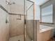Tiled walk-in shower with niche and glass surround next to tub at 1540 Orange Valley Rdg, Ocoee, FL 34761