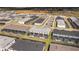 A beautiful aerial view of this townhome community with rear patios and screened in in-ground pools at 16061 Blue Wave Way, Clermont, FL 34714